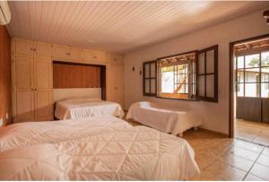 a bedroom with two beds and two windows at Hotel Boutique Pé Da Tartaruga in Teresópolis +96 photos