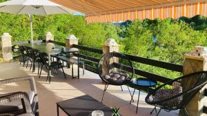 a patio with a table and chairs and an umbrella at VILA GIGI, ideala pentru relaxare si distractie! in Breaza