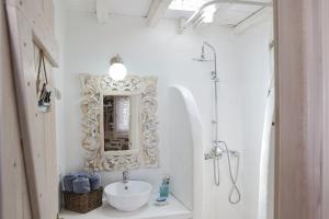 a bathroom with a sink and a mirror at Amelia Private Pool Apartment in Panormos Mykonos