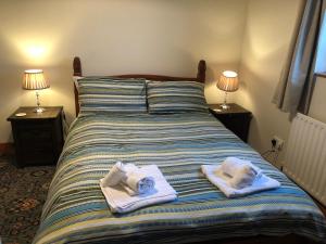 a bedroom with a bed with towels on it at Corraglass House - close proximity to Cuilcagh in Letterbreen