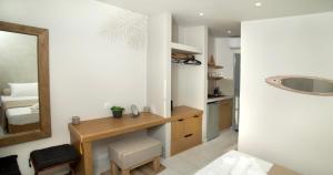a bathroom with a vanity and a mirror and a sink at Horizon Hotel Kalymnos in Myrties +37 photos