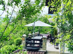 a patio with a table and an umbrella at VILA GIGI, ideala pentru relaxare si distractie! in Breaza