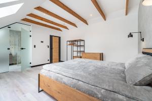 a bedroom with a large bed in a room at Villa Warminska in Kręsk