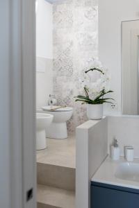 a bathroom with a sink and a toilet and a sink at FONTE D'OLIO CONERO RELAIS in Sirolo +39 photos