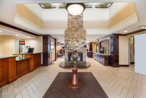 a lobby with a table and a fireplace at Sonesta ES Suites Torrance Redondo Beach in Torrance