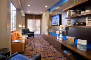 a living room with a couch and a tv at Sonesta Select Las Vegas Summerlin in Las Vegas