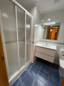 a bathroom with a shower and a sink at Apartamento vistas al mar in Viveiro +28 photos