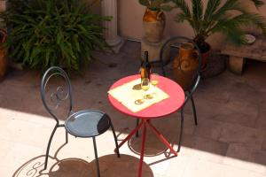 a red table with a pair of scissors on it at Antica Dimora - Ospitalità e Tradizione in Nardò
