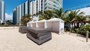 a building on the beach with palm trees and buildings at Penthouse Condo at Lyfe Resort and Residences in Hollywood