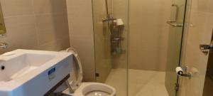 a bathroom with a shower and a toilet and a sink at 81 Newport,NAIA 3,Pasay Condotel in Manila