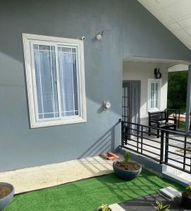 a porch with green grass and a window at Carnbee Cozy Cottage in Bethel