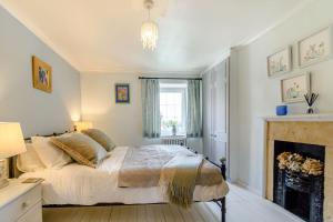 Ένα ή περισσότερα κρεβάτια σε δωμάτιο στο Snowdrop Cottage