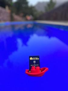 a small red toy boat sitting next to a pool at Atlas Ijoukak in Ijjoukak