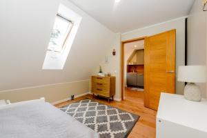 a bedroom with a bed and a window and a door at Karjamaa Apartment with Garden in Pärnu