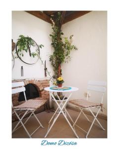 a table and chairs in a room with a fireplace at Domo Dizósa in Siniscola