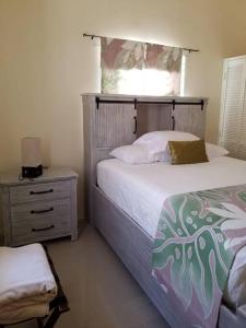 a bedroom with a large bed and a window at Villa verde Jamaica - Oceanview Getaway, Gated & Secured in Falmouth