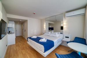 a bedroom with a large bed and a table at Orbi City Batumi Arena in Batumi