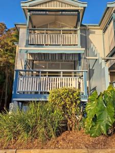 a large house with a balcony with a porch at Villa 20 in Tangalooma