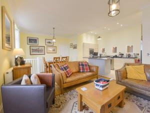 a living room with two couches and a table at The Old Signal House in Torpoint