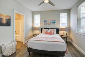 a bedroom with a bed and two windows at Tranquility Base Cottage in Ocean Shores