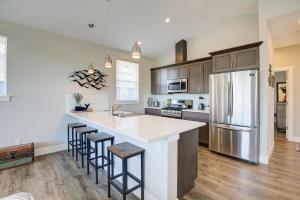 a kitchen with a large island with bar stools at Tranquility Base Cottage in Ocean Shores