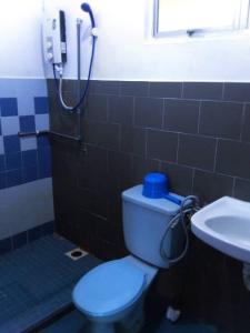 a bathroom with a toilet and a sink and a shower at Cocobay Resort Cosy Apartment in Kampong Tanah Merah