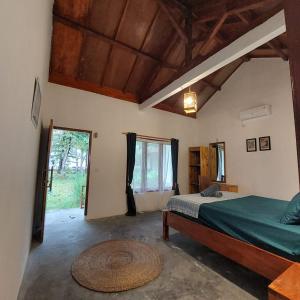 a bedroom with a bed and a large window at Kambuna Bungalow in Krui