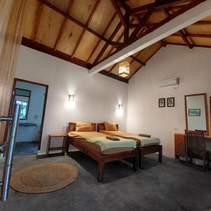 a bedroom with a bed in a room with wooden ceilings at Kambuna Bungalow in Krui +56 photos