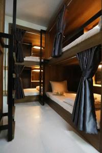 a room with three bunk beds in a hostel at Bui Vien Street Hostel in Ho Chi Minh City