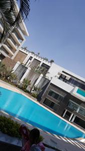 a building with a swimming pool next to a building at Sheraton Ocean 704 - Without Pool access in Cairo