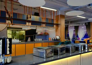 a kitchen with a bunch of trays on a counter at ADD Hotel Almaty in Almaty