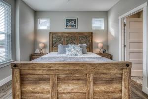 a bedroom with a large wooden bed and two lamps at Captains Seaside Retreat in Ocean Shores