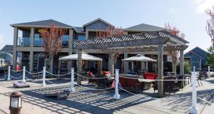 a building with a patio with tables and umbrellas at Captain's Seaside Retreat in Ocean Shores