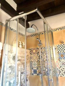 a shower in a bathroom with tiles on the wall at Apartamento Canónigo - terraza con vistas in Toledo