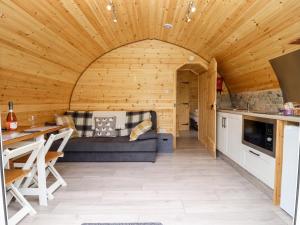 a living room with a couch and a table at Meadow Lodge Berrys Place Farm in Gloucester