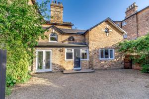 a brick house with a driveway in front of it at The Coach House in Scarborough