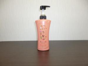 a pink shampoo bottle sitting on a wooden table at The Mickey Carlton Ohashi 205 in Fukuoka