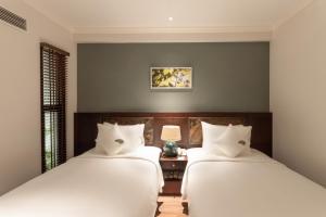 Postel nebo postele na pokoji v ubytování Cochin Sang Hotel