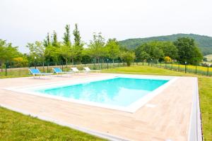 a swimming pool with two lounge chairs in a yard at Agriturismo Calamello in Pergola