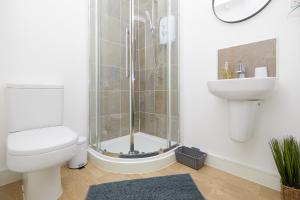 a bathroom with a shower and a toilet and a sink at Royal Derby Hospital House (2.5 bath) in Derby