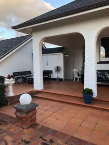 a porch of a house with a patio at Grand On Victoria in Hawera