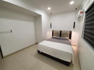 a small white room with a bed in it at Number A Homestay in Raub