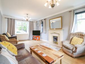 a living room with a couch and a fireplace at Pencraig in Colwyn Bay