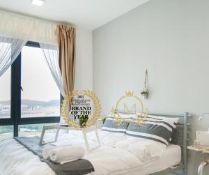 a bedroom with a bed with a sign on it at Miko's Sweethome @ Setia Alam in Setia Alam