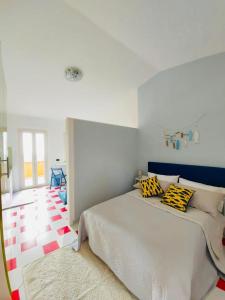 a bedroom with a large bed with yellow and black pillows at Orizzonte Tropea in Parghelia