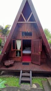 a small house with a bed in the middle at Bliss family cottage Batu in Batu