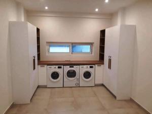 A kitchen or kitchenette at Two Olive Trees - Deluxe Apartments