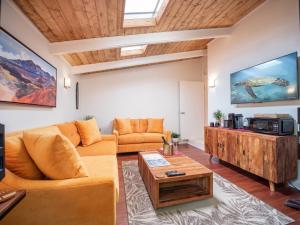 a living room with a couch and a table at Noahs Hideaway Luxury B&B in Lahaina