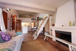 sala de estar con chimenea y escalera en Holiday home Can Pontico, en Pollensa