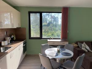 uma cozinha com mesa e cadeiras num quarto em Nikol Deluxe em Velingrad